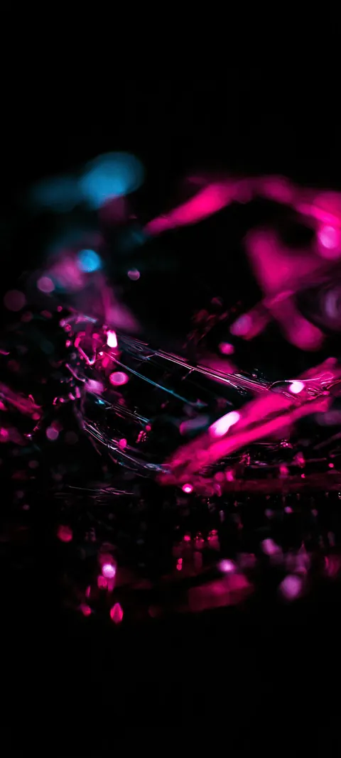 Sharp fuchsia crystal shards scatter through dark space, catching bright edges against the void.